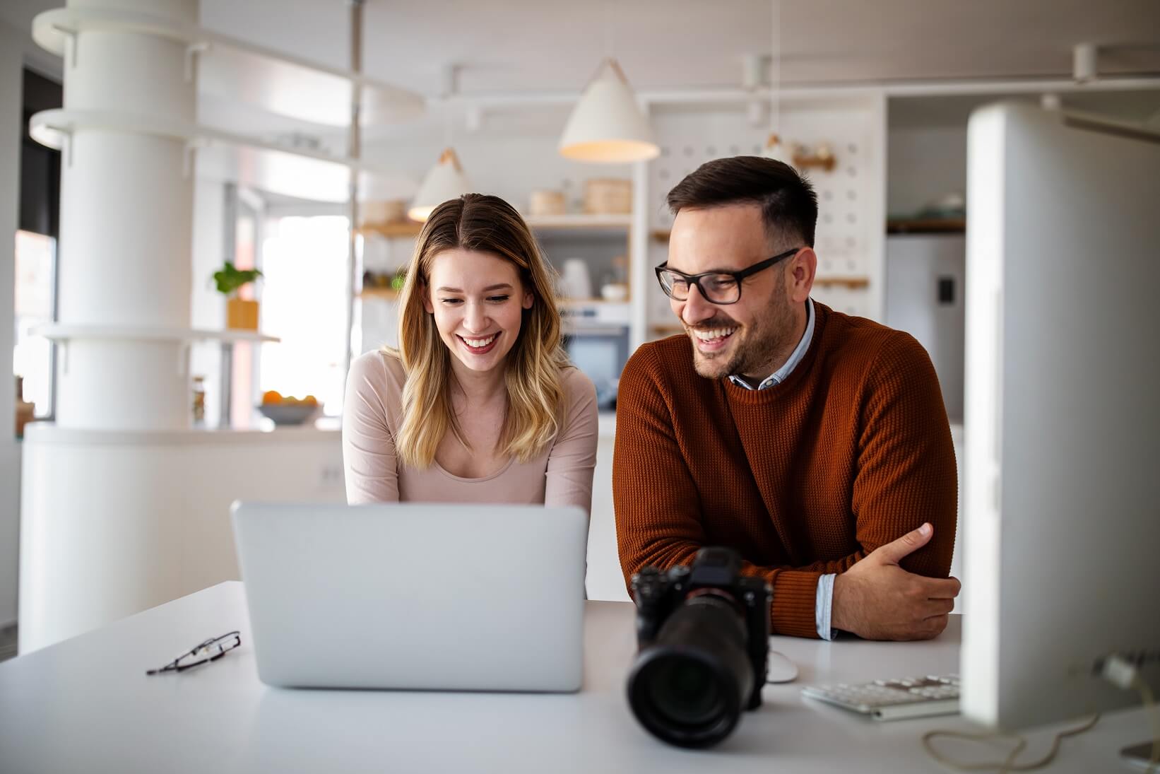 graphic-designers-working-in-office-with-laptop-te-MCCTSRL